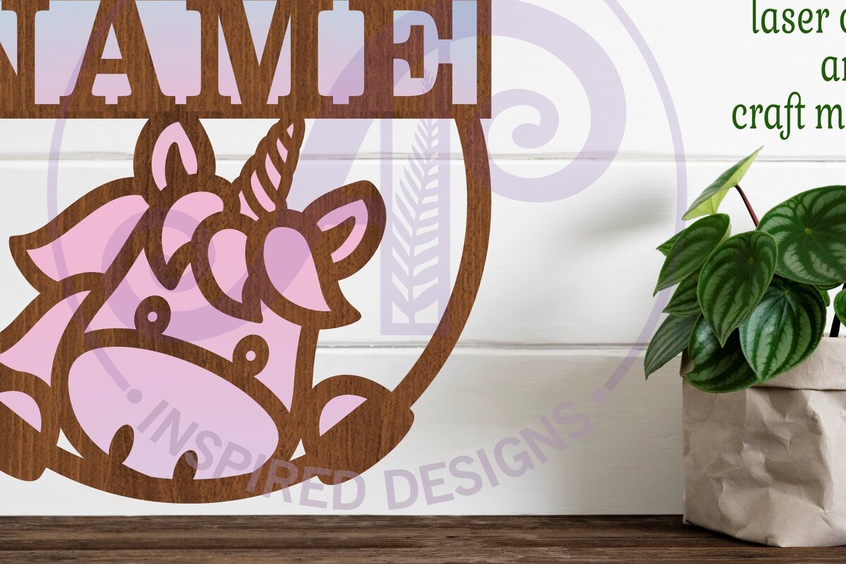 Σετ των 2 Intra απο ξύλο plywood 3mm-4mm πάχος – Μονόκερος που κρυφοκοιτάζει το όνομα Cut Laser Δίασταση  20x20 cm INTRAFABR-96173979