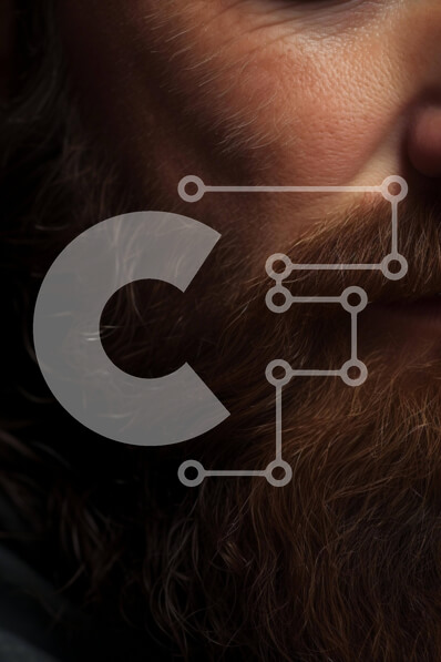 Intra Συλλεκτικό Ξύλινο Παζλ Plywood  4mm - Close-up πορτρέτο γενειοφόρου άνδρα με γυαλιά και κοσμήματα Σε Ξύλινο Κουτί - Διαστάσεις Puzzle: 10x10 cm – 25 κομμάτια