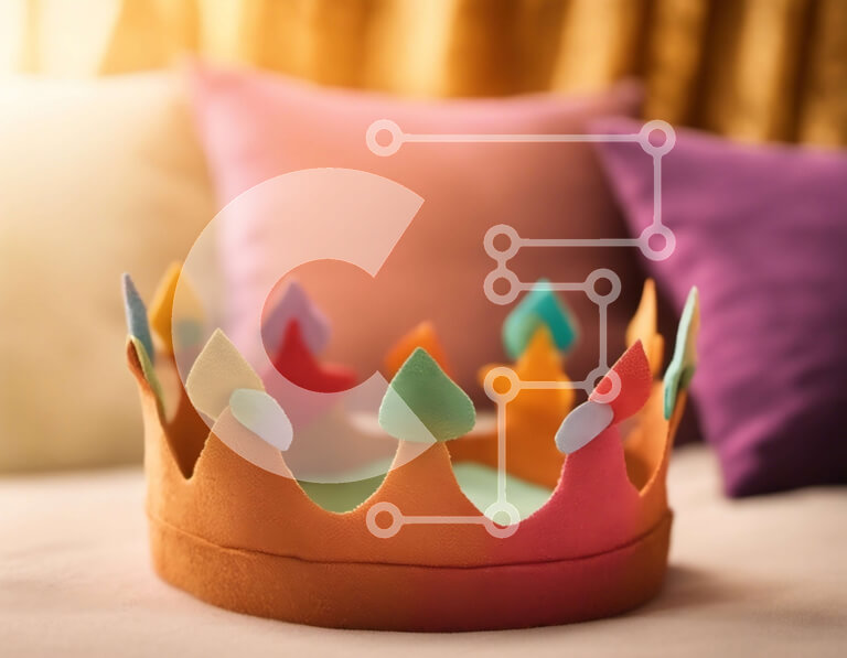 Intra Συλλεκτικό Ξύλινο Παζλ Plywood  4mm - Πολύχρωμο χάρτινο στέμμα στο κρεβάτι με κίτρινα και πορτοκαλί μαξιλάρια Σε Ξύλινο Κουτί - Διαστάσεις Puzzle: 10x10 cm – 25 κομμάτια