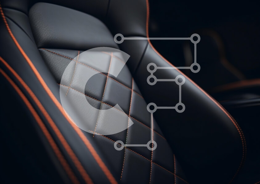 Intra Συλλεκτικό Ξύλινο Παζλ Plywood  4mm - Κοντινό πλάνο ενός πολυτελούς καθίσματος αυτοκινήτου με διαμαντένιο σχέδιο και πορτοκαλί ραφές Σε Ξύλινο Κουτί - Διαστάσεις Puzzle: 10x10 cm – 25 κομμάτια